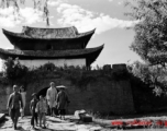 Local people in China in front of a town gate near Yangkai, Yunnan.  From the collection of Eugene T. Wozniak.