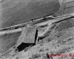 An apparent mill house over a canal, and farmers walking path, in Yunnan province, China, during WWII.  From the collection of Eugene T. Wozniak.