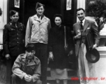 An elite Chinese woman poses with American servicemen and local people in Yunnan province, China, during WWII. 