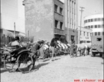 Scenes around Kunming city, Yunnan province, China, during WWII: Street and lined up rickshaws.