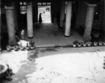 An American soldier walks in a quiet courtyard somewhere in Guizhou province, probably Anshun city or Guiyang (Kweiyang) city.  Since Guiyang was the capital of Guizhou, Americans often used that name for the whole province.
