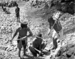 Laborers breaking stone by hand tools in southwest China, during WWII.