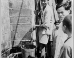 Local people drawing water from a well in China during WWII.  Photo from M. J. Hollman.