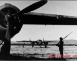 Chinese soldier keeps guard over B-25s in SW China during WWII.