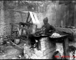 A street-side silk spinner, in SW China, during WWII.