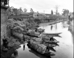 Boats in a canal in Yunnan province, China, possibly near Kunming, during WWII.