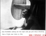 Dale Stronbehn looking out the right side gun port while returning from a flight over India in 1944.