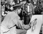 U. S. Combat Artist, Sgt. R. Zounes, draws a Lisu woman along the Burma Road, during WWII.