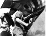 GIs change film on an F-5 (a reconnaissance version of the P-38) in the CBI during WWII.