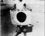 George M. Corrington display a  shows off trophy captured Japanese Good-Luck Flag  (寄せ書き日の丸) he picked up at battlefield at Kohima.  Photo by Tom D. Davis.