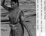 An Indian woman carries two huge rocks on her head at a construction site. During WWII.  Photo from Delbert Wood.