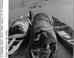 Boats in a Kunming canal, where women appear to be fishing. These boats are also their homes. During WWII.