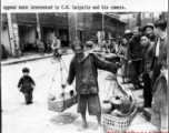 A Chinese vendor carries his goods on a shoulder pole in the CBI during WWII.  Photo by C. W. Leipnitz.