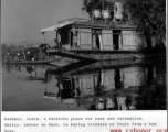 A boat on the water at Kashmir, India, during WWII, and Smitty, center on deck, buying trinkets or fruit from the bum boat.  Photo from Robert T. Keagle.