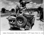 Combat Photographer T/Sgt. Syd Greenberg, 164th Signal Photographic Company, with his Mitchell mobile camera along the Burma Road in 1944. In the CBI in 1944.  Photo by Sgt. Ackerman.