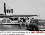 The boat "CHUNDI" takes on passengers and one automobile for travel on an Indian river during WWII.