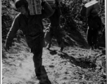 GIs carry 10 lb ration boxes on a trail, possibly after airdrop in Burma or SW China