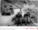 Three GIs stop to move roller out of the way... or pretend to for the camera. In the CBI during WWII.