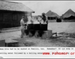 GIs washing mess kits at camp in Guilin, during WWII.