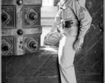 Frank Bond of the 40th Photographic Reconnaissance Squadron squeezes through a small door in a massive gate of a Hindu temple in Madras, India, during WWII.  Photo from Glenn S. Hensley.