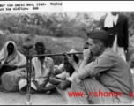 A GI tries out a smoking pipe in the old Delhi market in 1942.