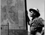 A GI reads about the war on a news board in Akyab.