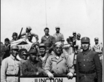 Soldiers pose at junction of Burma & Ledo Roads during WWII.