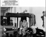 A GI writes at a bunk in Photo Recon Squadron barracks during WWII.  Photo from Robert Travis Keagle.