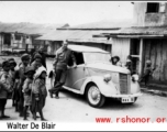 GI leans against car in the CBI during WWII. Walter De Blair.