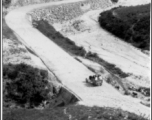 A vehicle passes along a newly cut road in SW China during WWII.