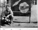 Gordon Brown kneels before 16th Fighter Group Sign At Chenggong (Chengkung), 15 miles from Kunming, during WWII. In Chinese the sign says "Great Wall In The Air" ("空中长城").  Photo from Gordon Brown.