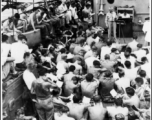 GIs gathered for a Protestant church service on deck of a ship (the Marine Raven) on the return voyage back to the US after the war.  In the CBI during WWII.