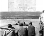 Three Chinese men observe a parked L-14 . Near Mitu, in the CBI during WWII.  U. S. Army Signal Corps Photo.