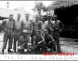 Men of the 1791st Ordnance Company, 52nd Air Services Group, pose for a photo in front of huts, during WWII.