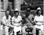 Nurses and GIs pose on a bench for the camera in the CBI during WWII.  Photo from Bruno F. Birsa.