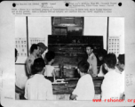 A Chinese officer and American non-com supervise a class in aerial gunnery in the CBI during WWII, as part of Operational Training. 