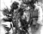 Chinese soldiers with mortar ready, and covered in camouflage during exercises in southern China, in Yunnan province.  Despite the appearance of being on their way to battle, these men are more likely in fact prepared for a demonstration or honor parade. 