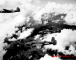 B-25 Mitchell bombers, including tails nos #264650 and #129900, in flight in the CBI, in the area of southern China, Indochina, or Burma.