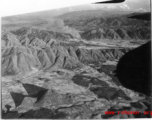 Smoke rises after attack by B-25 Mitchell bombers during battle with Japanese ground forces, flying in the rough area of Tengchung (Tengchong), near the China-Burma border in far SW China.