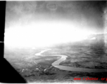 An image of a river and the ground as seen from a B-25 Mitchell, in SW China, or Indochina, or the China-Burma border area.