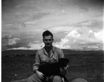 The photographer and collector (name unknown) of this collection, with some large bombs and a dog, most likely around the Luliang air base area. A tent camp is in the far background.