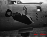 Nose art of a B-24 bomber, showing a women riding a falling bomb. During WWII, in China.