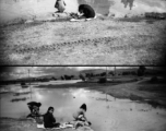 Women doing laundry in pond near American air base in China during WWII.