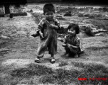 A boy and girl playing in Yunnan, China, near an American air base. During WWII.