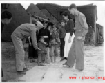 Chaplain Mengel lead his men to participate in outreach to the wartorn and impoverished Chinese countryside. These photos from Chaplain Mengel's private collection, show him with General Chennault, giving out donations from the US airmen.