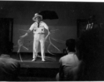 Celebrities visit and perform at Yangkai, Yunnan province, during WWII: Performer does a rope act for  the GIs, as caught by Wozniak in long-exposure photography.