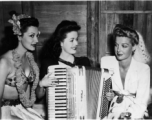 Celebrities visit and perform at Yangkai, Yunnan province, during WWII: Jinx Falkenburg, Ruth Dennis, and Ann Sheridan pose together.