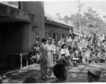 Celebrities (including Ann Sheridan in this shot) perform on an outdoor stage set up at the "Last Resort" at Yangkai, Yunnan province, during WWII. Notice both Americans and Chinese in the audience for this USO event.