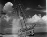 Boat 'Icaros", #H211, aground on the sandy shore in India.  Scenes in India witnessed by American GIs during WWII. For many Americans of that era, with their limited experience traveling, the everyday sights and sounds overseas were new, intriguing, and photo worthy.