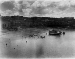 Fancy buildings alongside a river.  Scenes in India witnessed by American GIs during WWII. For many Americans of that era, with their limited experience traveling, the everyday sights and sounds overseas were new, intriguing, and photo worthy.